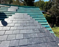 Natural slate roof being laid over fresh underlay during a Gloucestershire re-roof