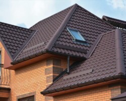 Large multi-gable brown tiled roof after a complete roof replacement in Gloucestershire