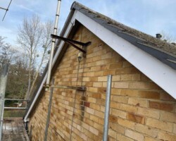 New brickwork gable with white bargeboard during roofing works in Gloucestershire