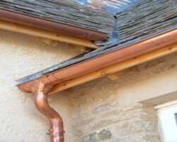 Copper guttering and downpipe on a stone cottage in Gloucestershire