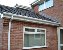 Brick extension with a new pitched tile roof and white fascia in Gloucestershire