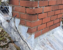 New lead flashing dressed around a chimney base in Gloucestershire