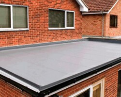 New grey GRP fibreglass flat roof on a brick extension in Gloucestershire