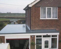Grey flat roof over a garage extension on a Gloucestershire home