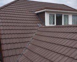 New brown tiled roof with white fascia on a Gloucestershire house