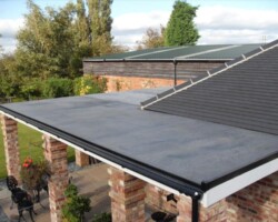 New grey EPDM flat roof on a pillared garden room in Gloucestershire