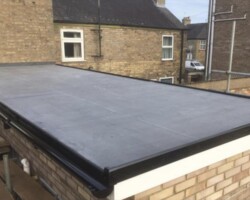 Black EPDM rubber flat roof with brick parapet on a Gloucestershire property